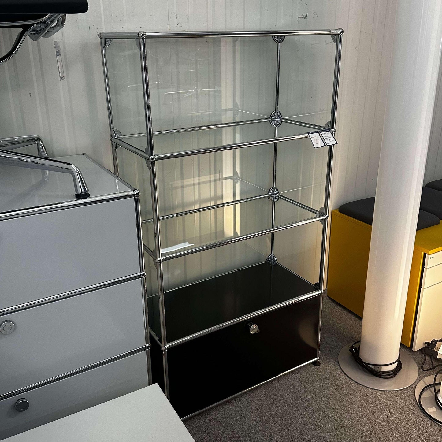 USM Haller Vitrine black with glass shelves and fold-down front door display cabinet