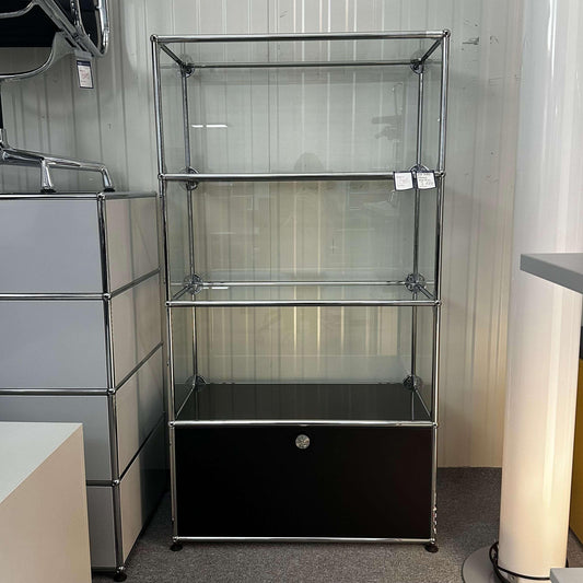 USM Haller Vitrine in black with glass shelves and front flap door