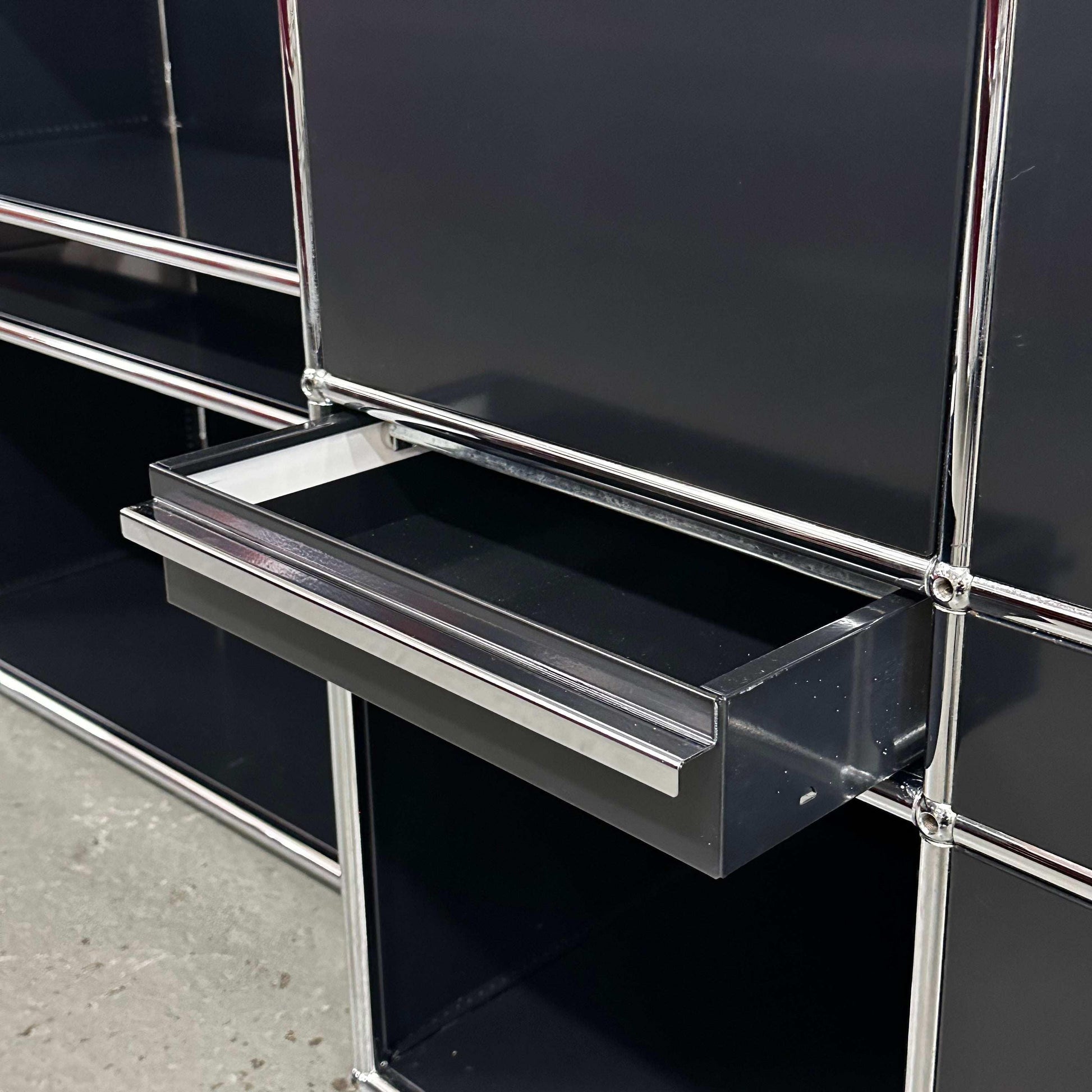 USM Haller black and stainless steel washbasin with open drawer and multiple compartments