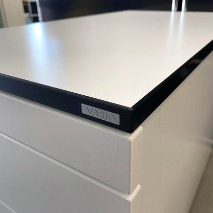 Close-up of Vario VERSA S Rollcontainer with premium white surface and black edge trim.