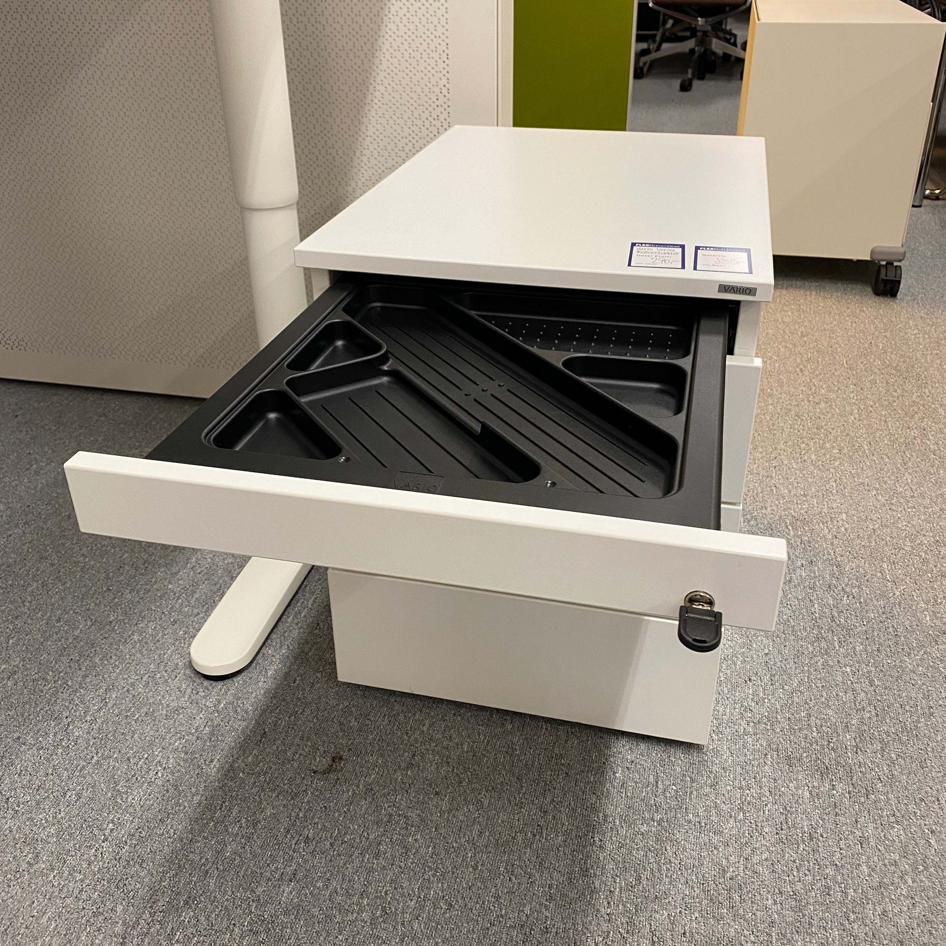 White Vario Versa Rollcontainer with four drawers, one open showing black organizer tray, compact office storage unit.