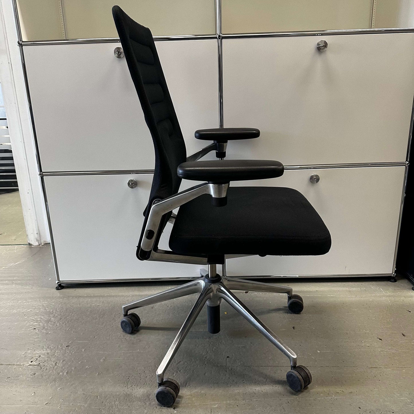 Vitra AC 4 ergonomic black office chair with chrome frame and adjustable armrests on caster wheels