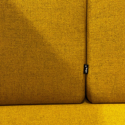 Close-up of mustard yellow fabric upholstery on Vitra Alcove Cabin Highback with visible Vitra brand tag