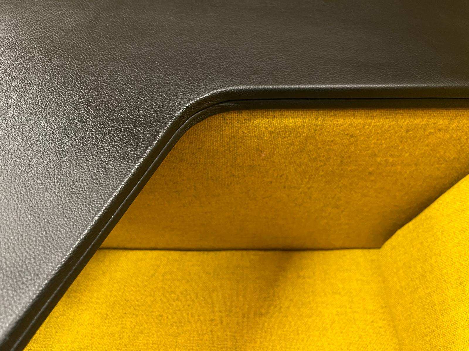 Close-up of yellow fabric interior and black frame of Vitra Alcove Highback Work chair