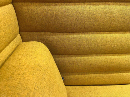 Close-up of Vitra Alcove Highback Work in vibrant yellow upholstery with textured fabric and horizontal panel design