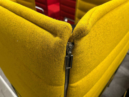 Close-up of yellow Vitra Alcove Highback work chair with visible zipper detail and textured fabric upholstery