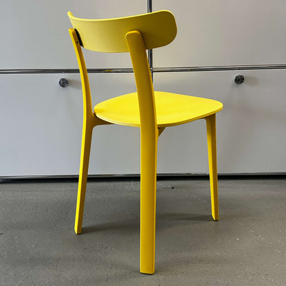 Vitra All Plastic Chair in bright Butterblume yellow with minimalist design and durable plastic construction.