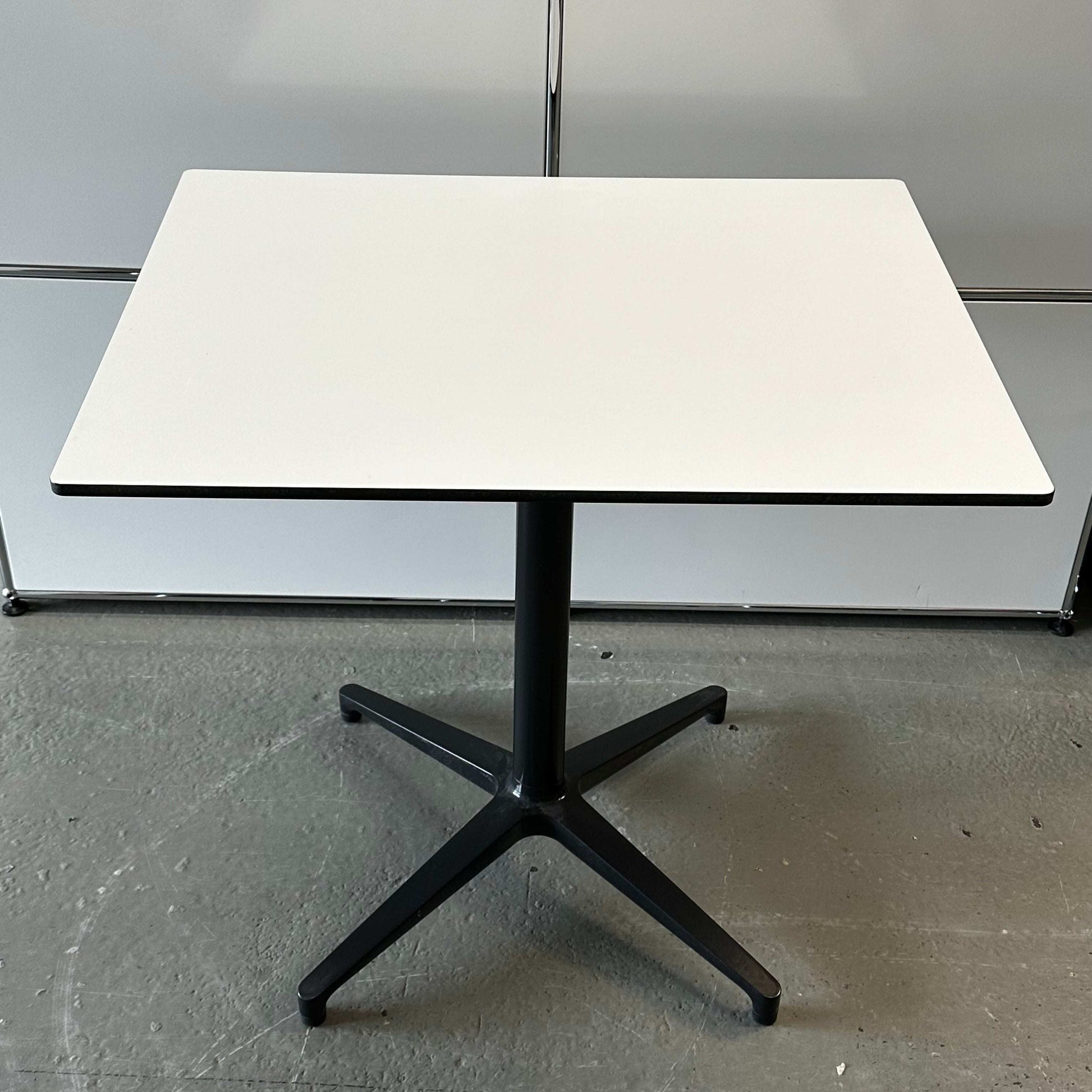 Vitra Bistro Table with white rectangular top and black star-shaped base, suitable for indoor and outdoor use