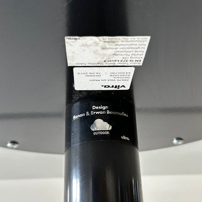 Close-up of Vitra Bistro Table black metal leg with designer label by Ronan & Erwan Bouroullec, suitable for outdoor use