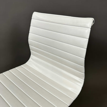 Vitra EA 101 white leather office chair with aluminum frame and no armrests.