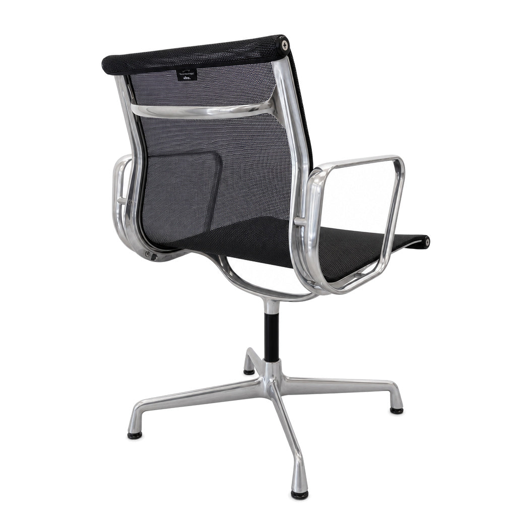 Vitra Eames Alu Chair EA 103 mit schwarzem Netzbezug und poliertem Aluminiumgestell in Rückansicht.