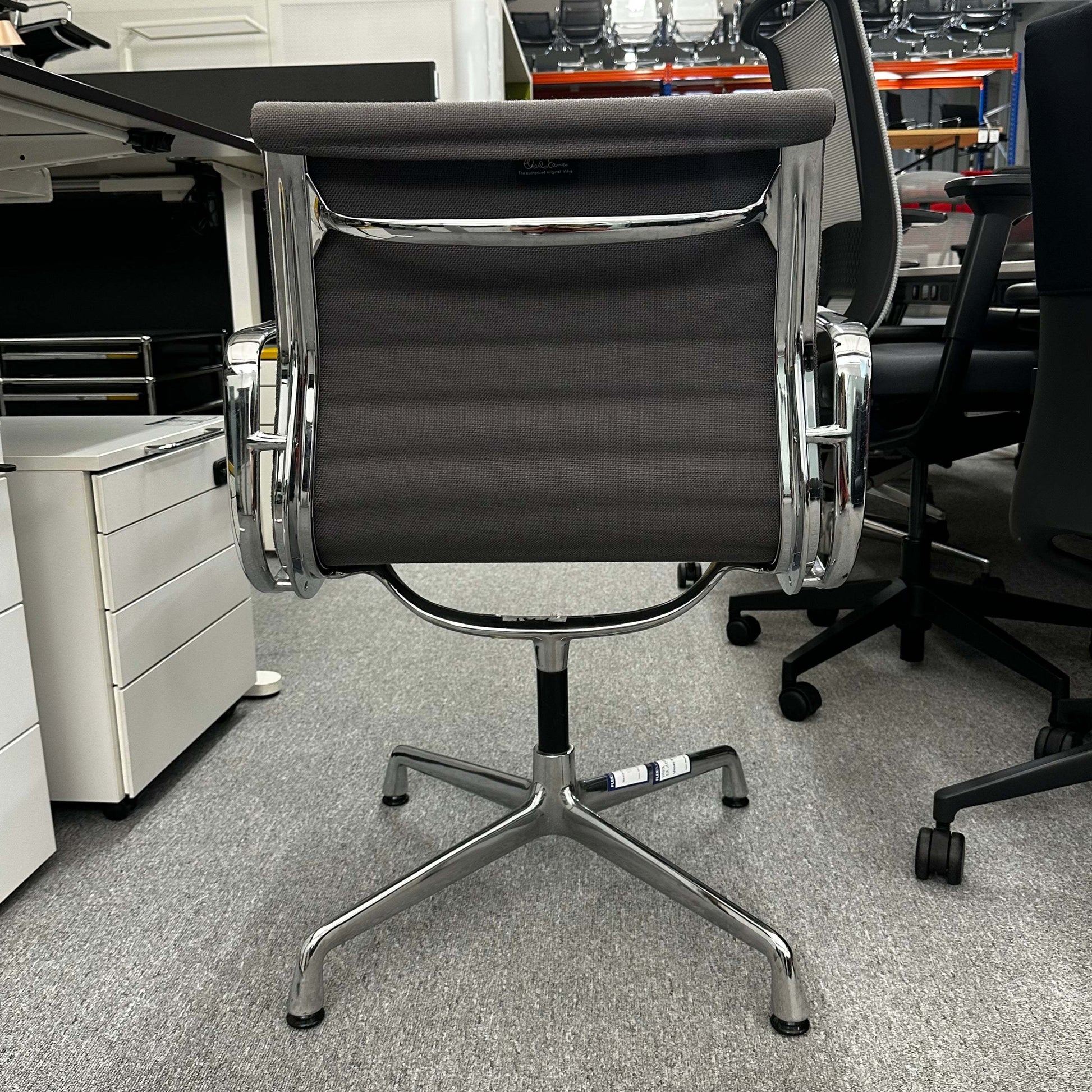 Vitra EA 107 office chair in medium gray hopsak fabric with non-swivel chrome base viewed from the back