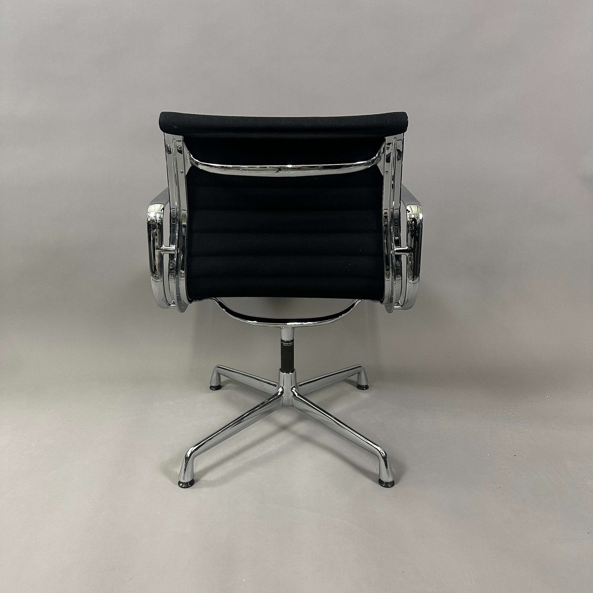 Black Vitra EA 107 Hopsak office chair with chrome aluminum frame, non-swivel design viewed from the back
