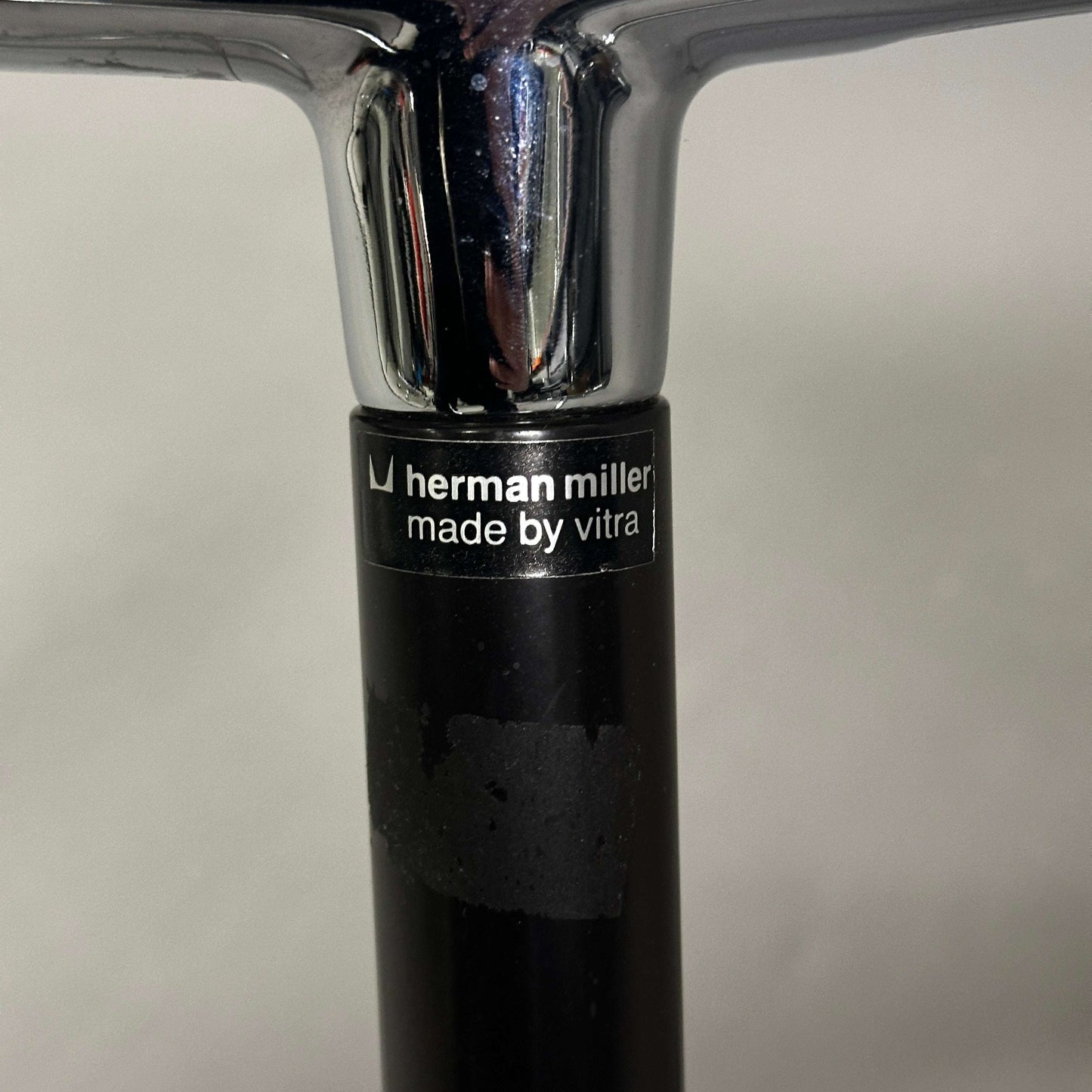 Vitra EA 107 Hopsak black chair with non-swivel chrome aluminum frame and Herman Miller label