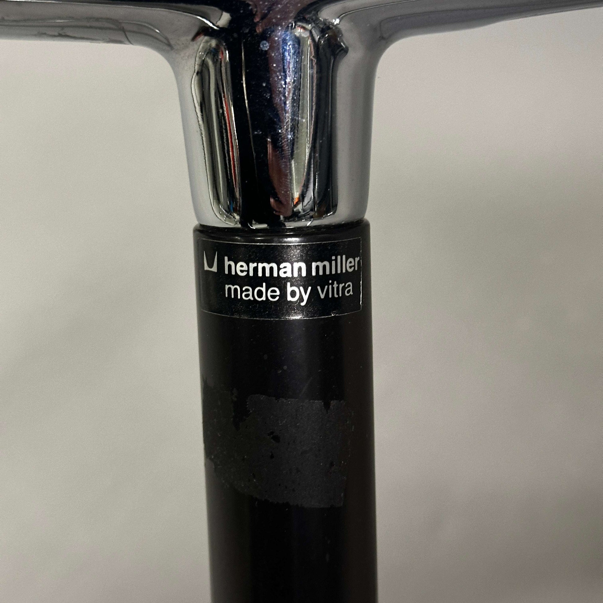 Vitra EA 107 Hopsak black chair with non-swivel chrome aluminum frame and Herman Miller label