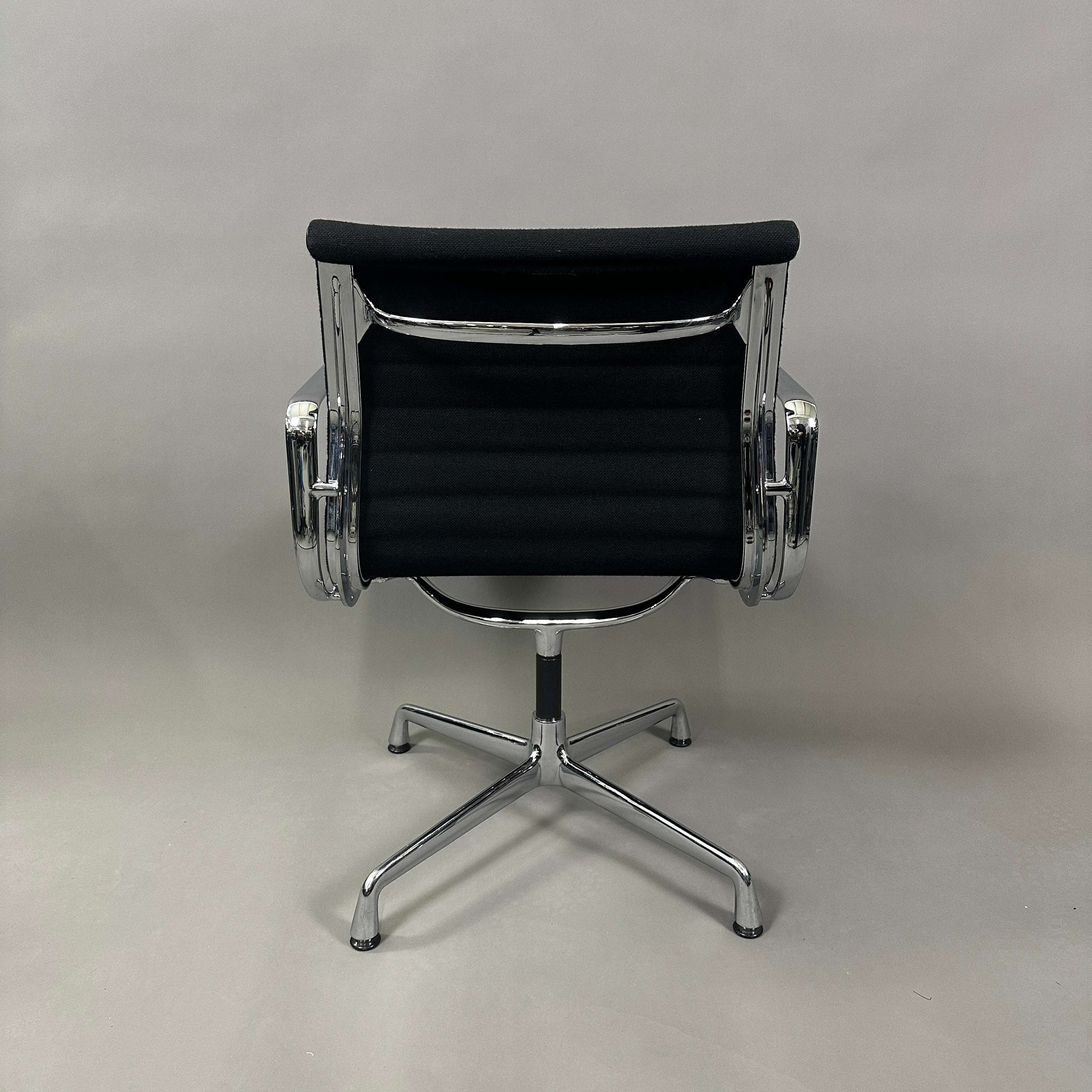 Vitra EA 108 black Hopsak fabric office chair with chrome frame and swivel base viewed from the back