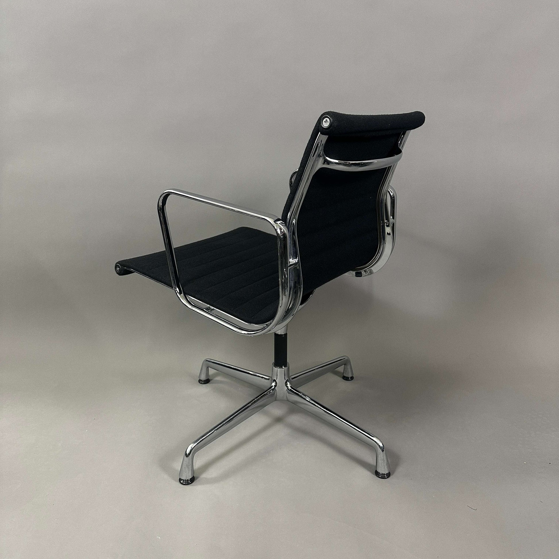 Vitra EA 108 black Hopsak upholstered swivel chair with chrome frame viewed from back