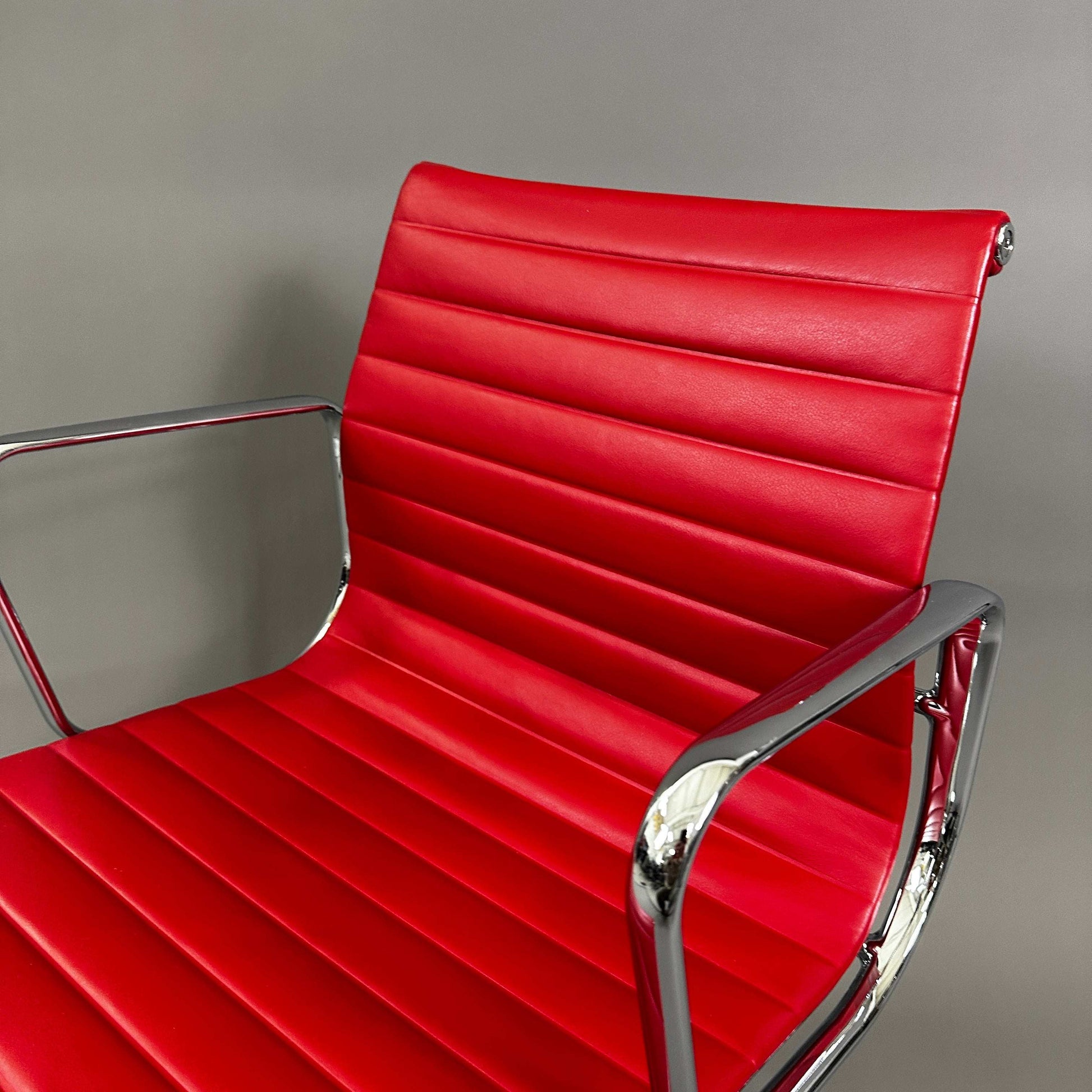 Vitra EA 108 red leather swivel chair with chrome frame