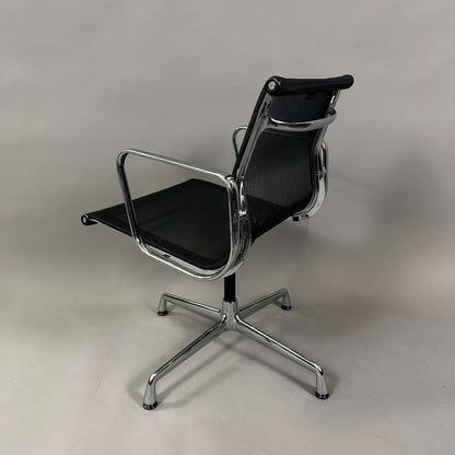 Vitra EA 108 black mesh swivel office chair with chrome frame and armrests