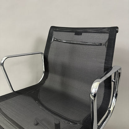 Vitra EA 108 black mesh swivel office chair with chrome frame and armrests