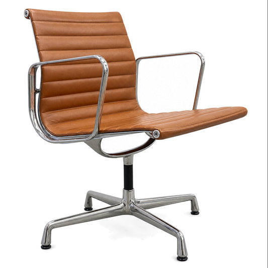 Vitra EA 108 Eames Alu Chair in cognac premium leather with a polished aluminum frame and swivel base.