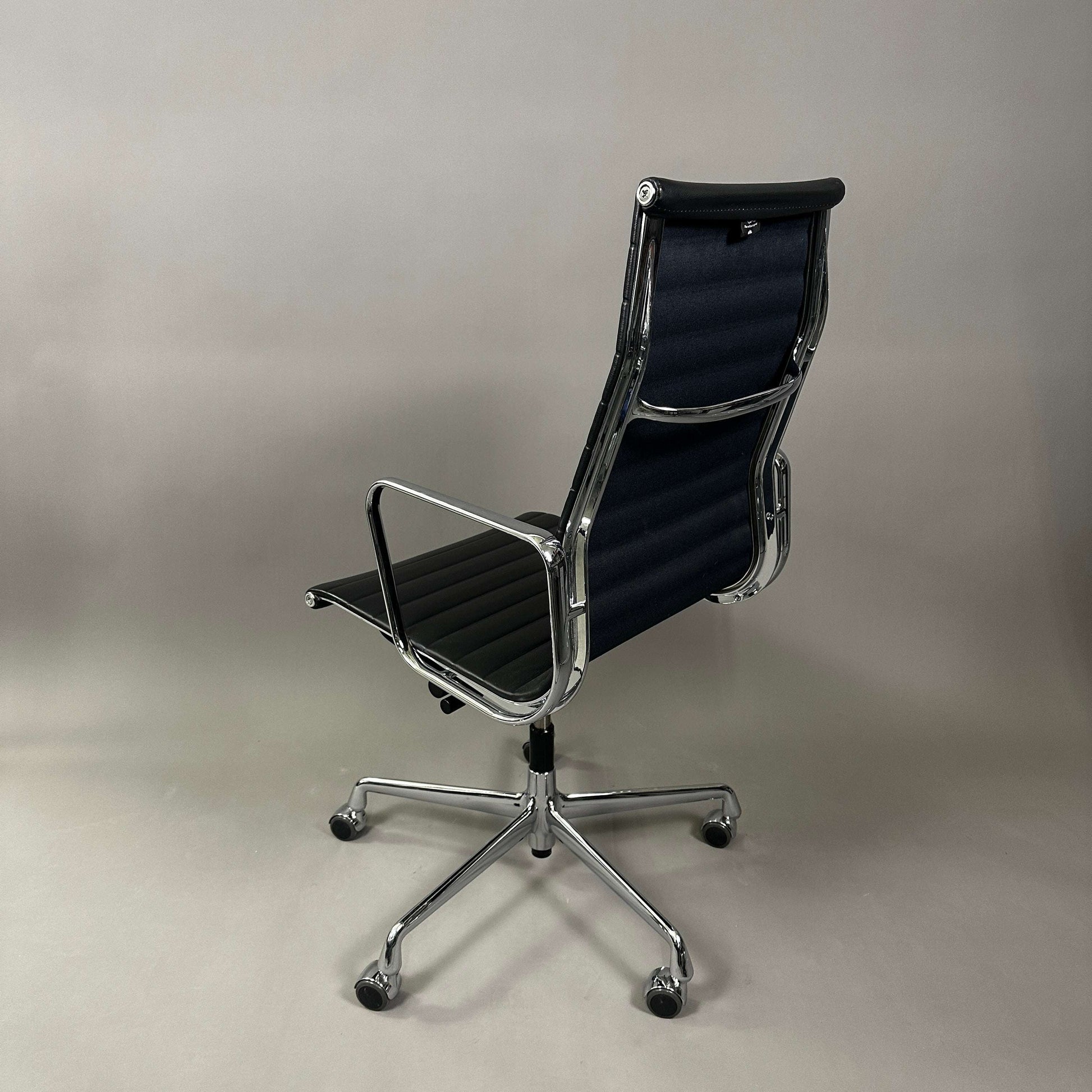 Vitra EA 119 office chair in black leather with chrome frame and adjustable tilt function