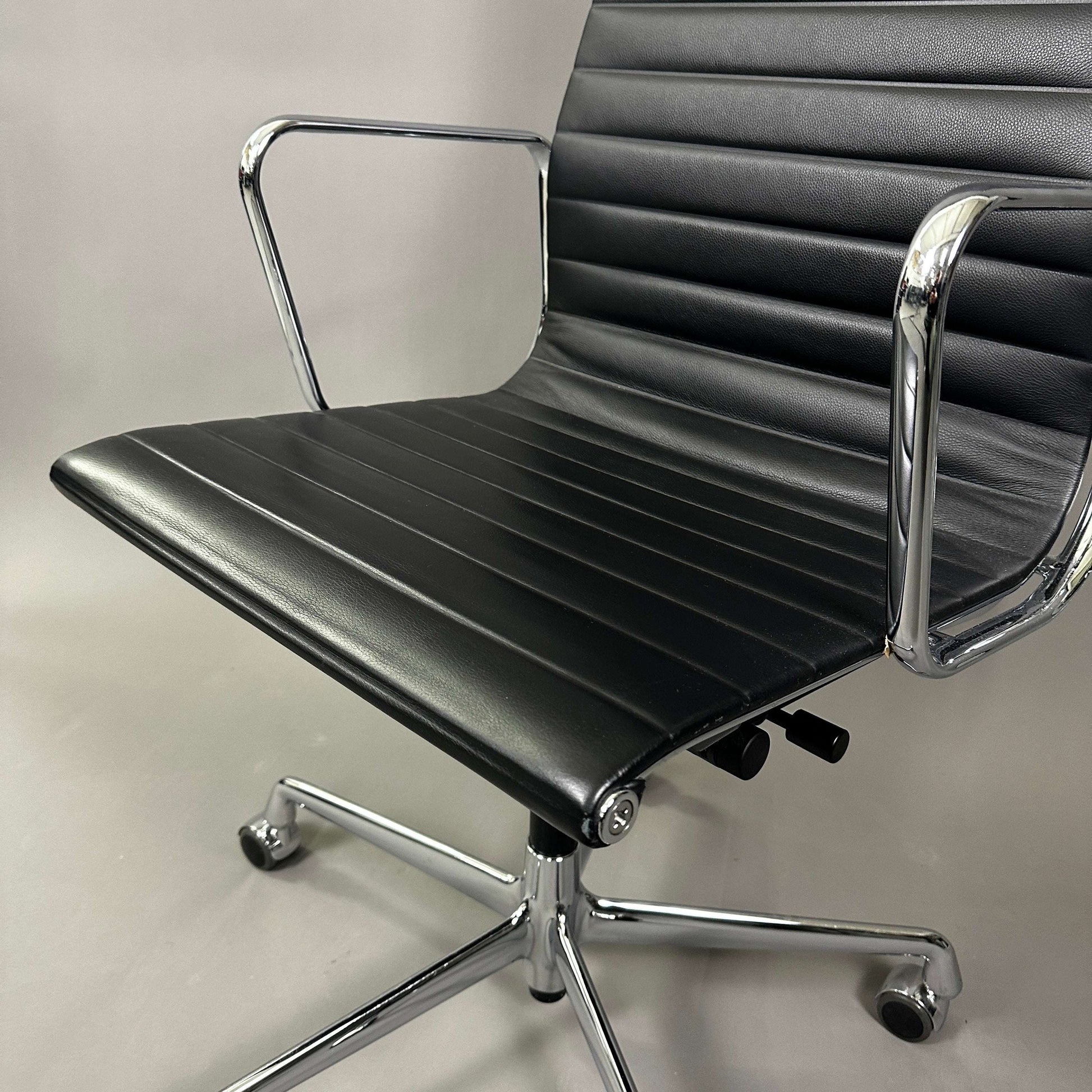 Vitra EA 119 office chair with black leather seat and chrome frame