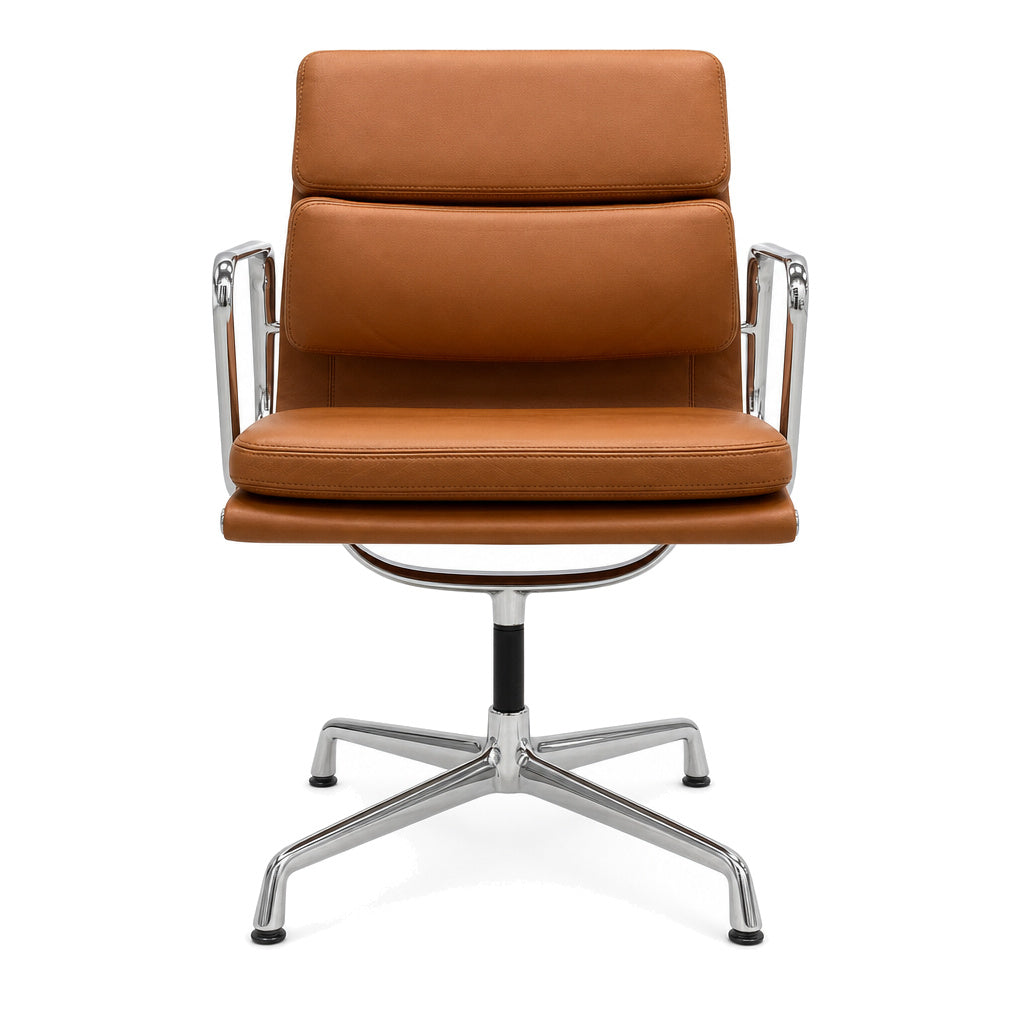 Vitra Eames EA 208 Bürostuhl aus cognacfarbenem Premium-Leder mit verchromtem Aluminiumgestell und Armlehnen.