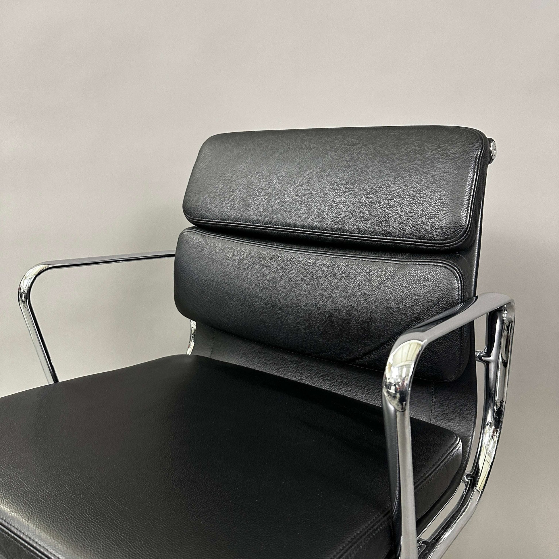 Vitra EA 208 black leather soft pad chair with chrome frame and swivel base