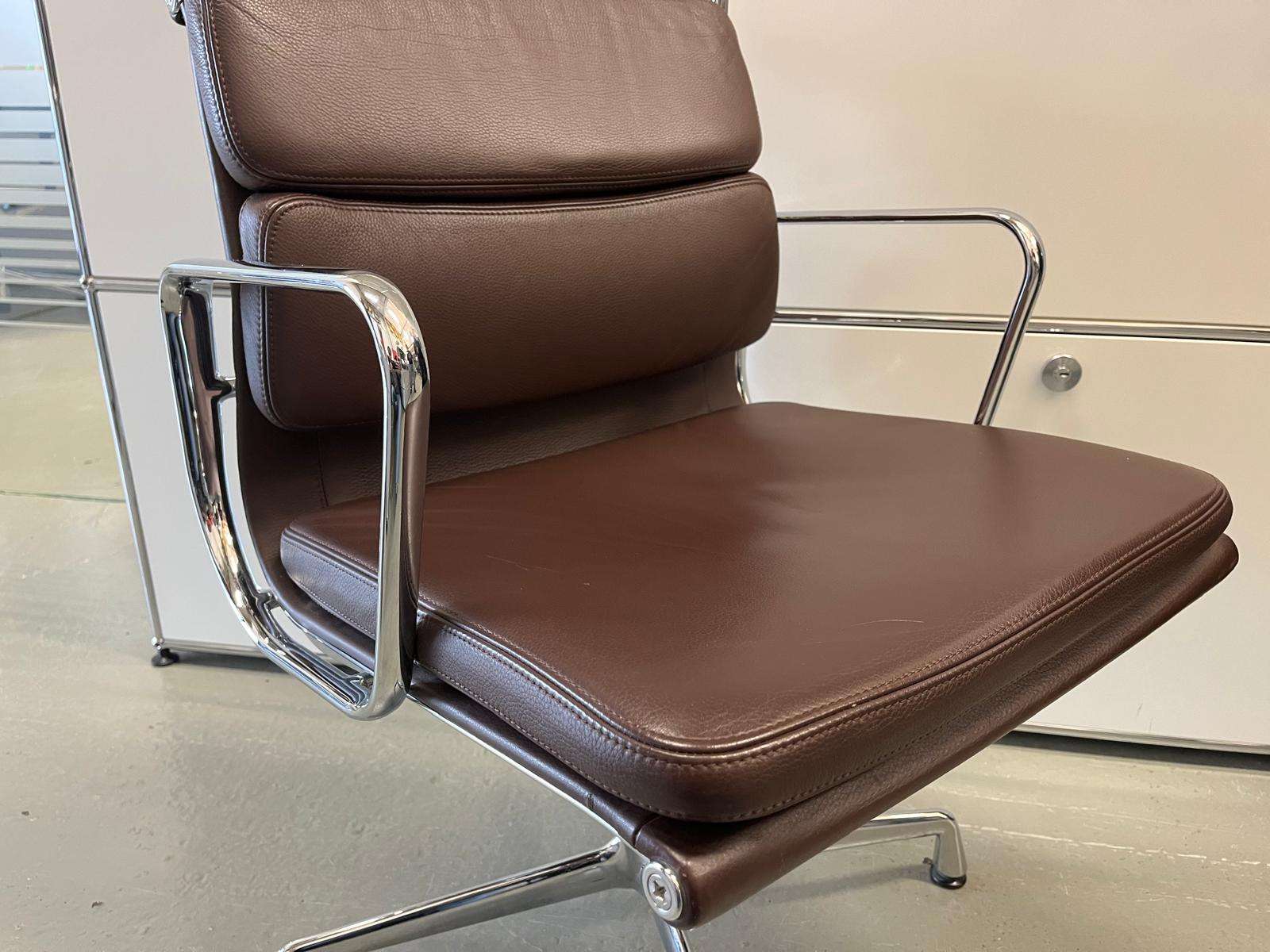 Vitra EA Soft Pad Chair in chestnut brown with chrome frame and soft padded swivel seat and backrest