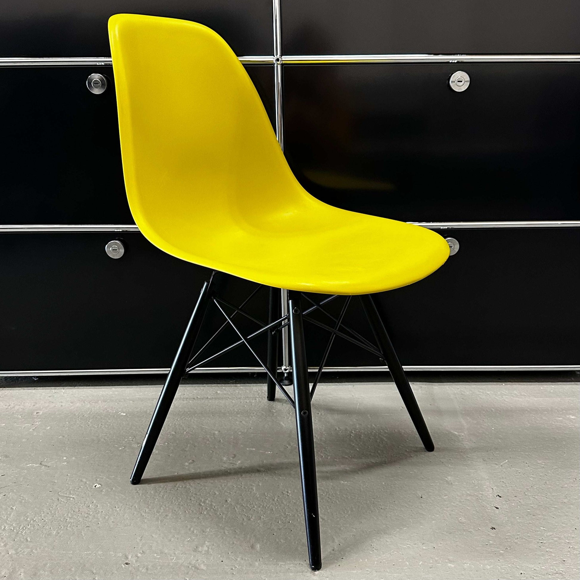 Vitra Eames Plastic Sidechair with mustard yellow seat and black wooden legs