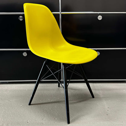 Vitra Eames Plastic Sidechair with mustard yellow seat and black wooden legs