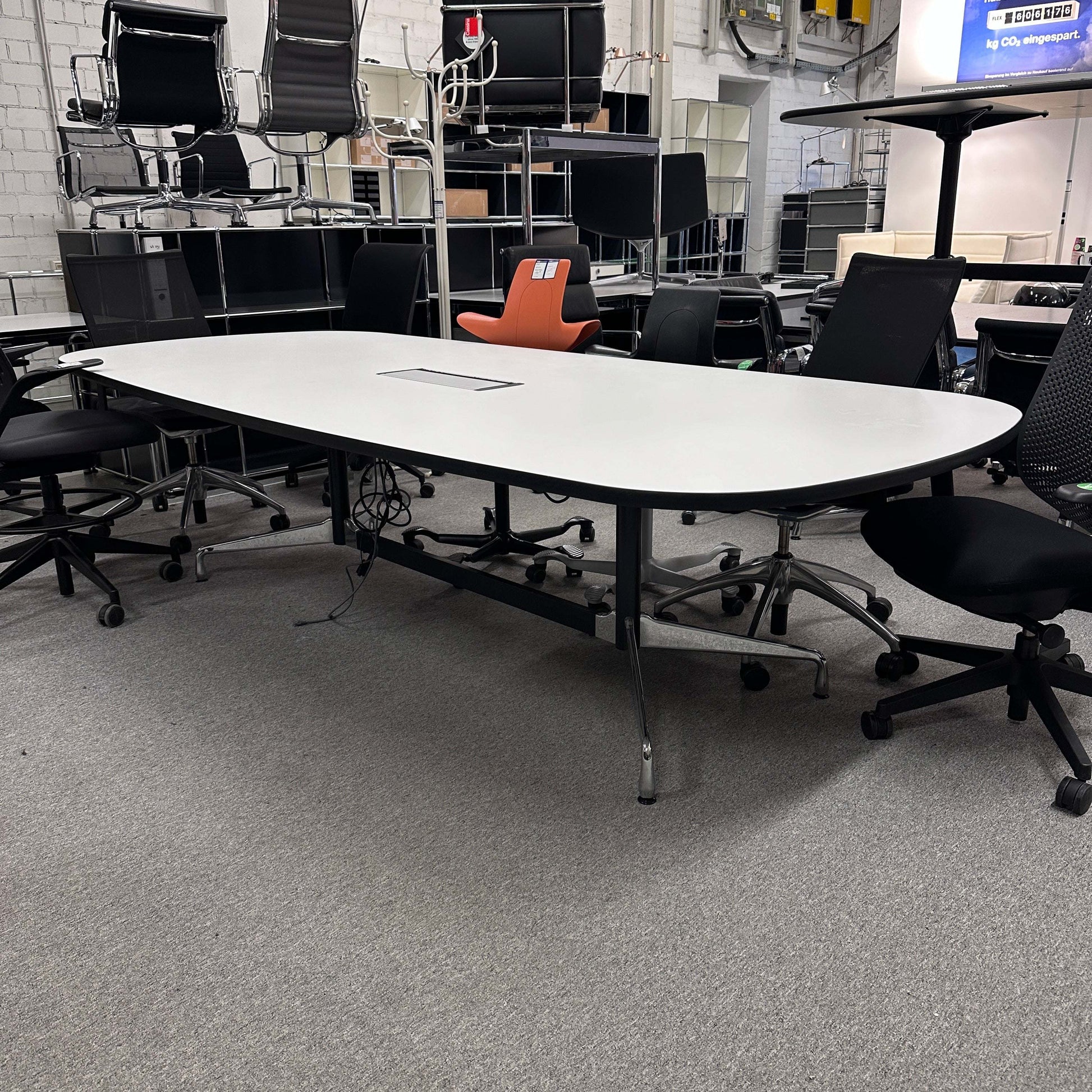 Vitra Eames Segmented Table 280x130 cm mit weißer HPL-Tischplatte und Mediakit in modernem Büroumfeld