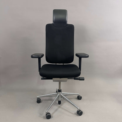 Vitra Headline black office chair with fabric seat, leather headrest, adjustable armrests, and chrome base