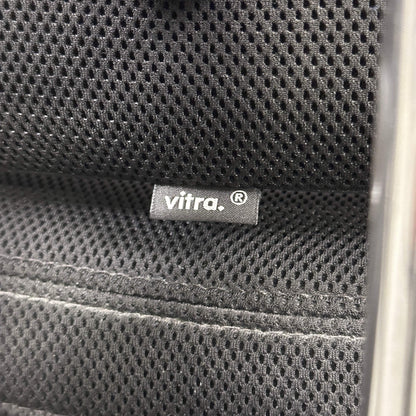 Close-up of black mesh fabric with Vitra brand label on the Vitra Headline office chair