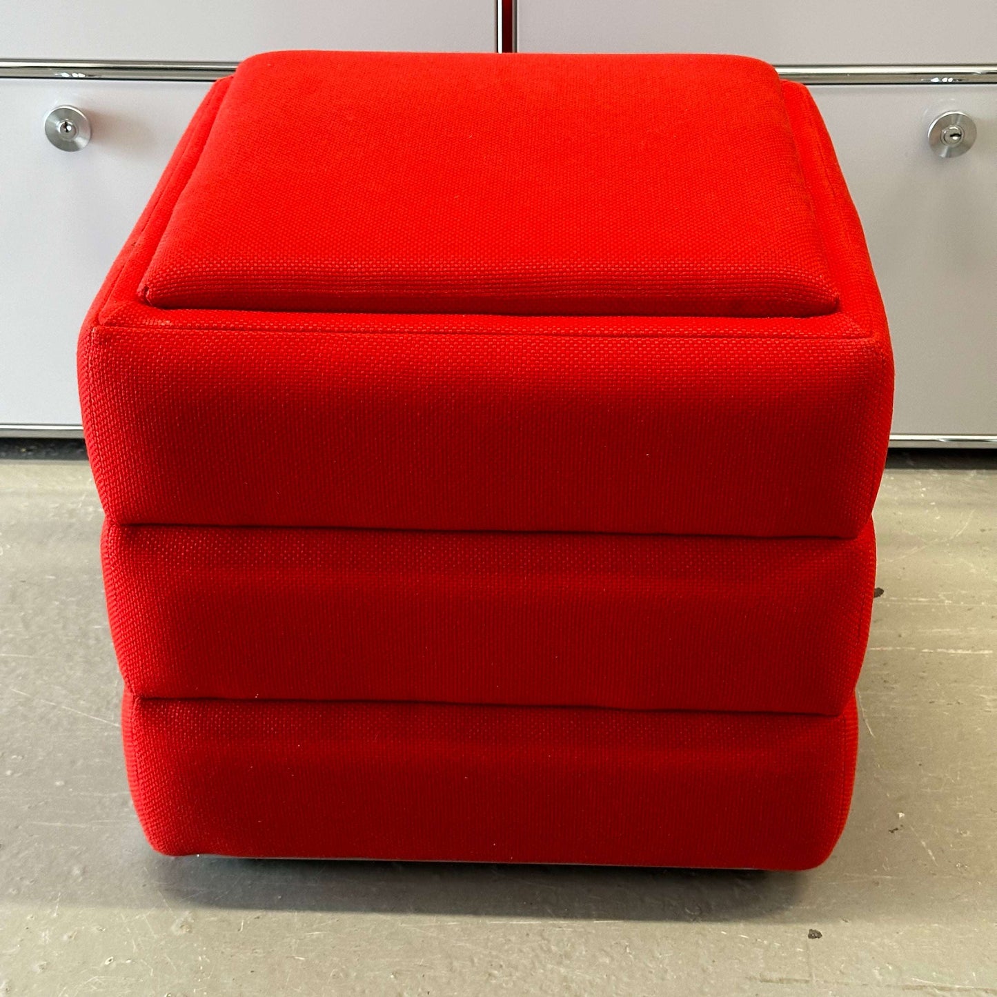 Red Vitra Hopsak Hocker stool upholstered in textured fabric, measuring 48x48x43cm.