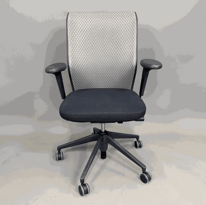 Vitra ID Mesh ergonomic office chair with grey mesh backrest, black seat, adjustable 3D armrests, and lumbar support