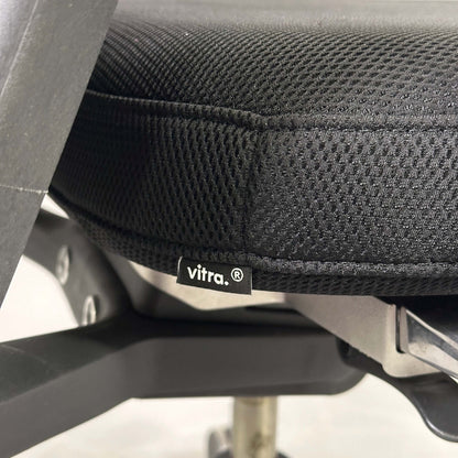 Close-up of black Vitra ID Mesh office chair seat with fine silk mesh fabric and adjustable ergonomic features