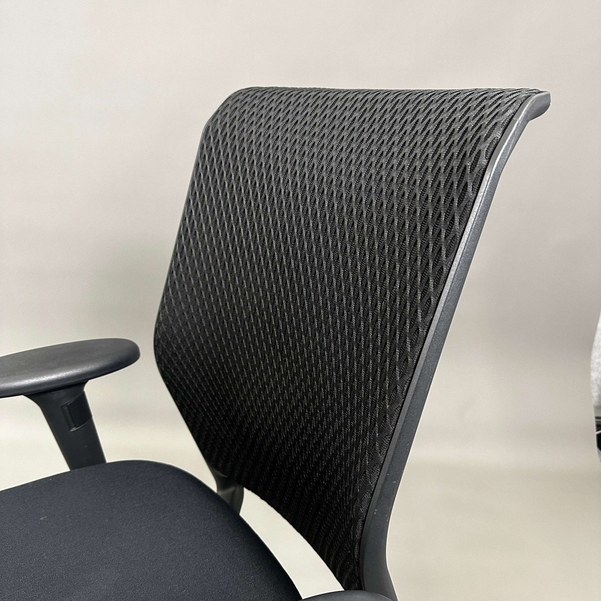 Black Vitra ID Mesh office chair with diamond mesh backrest and adjustable armrests