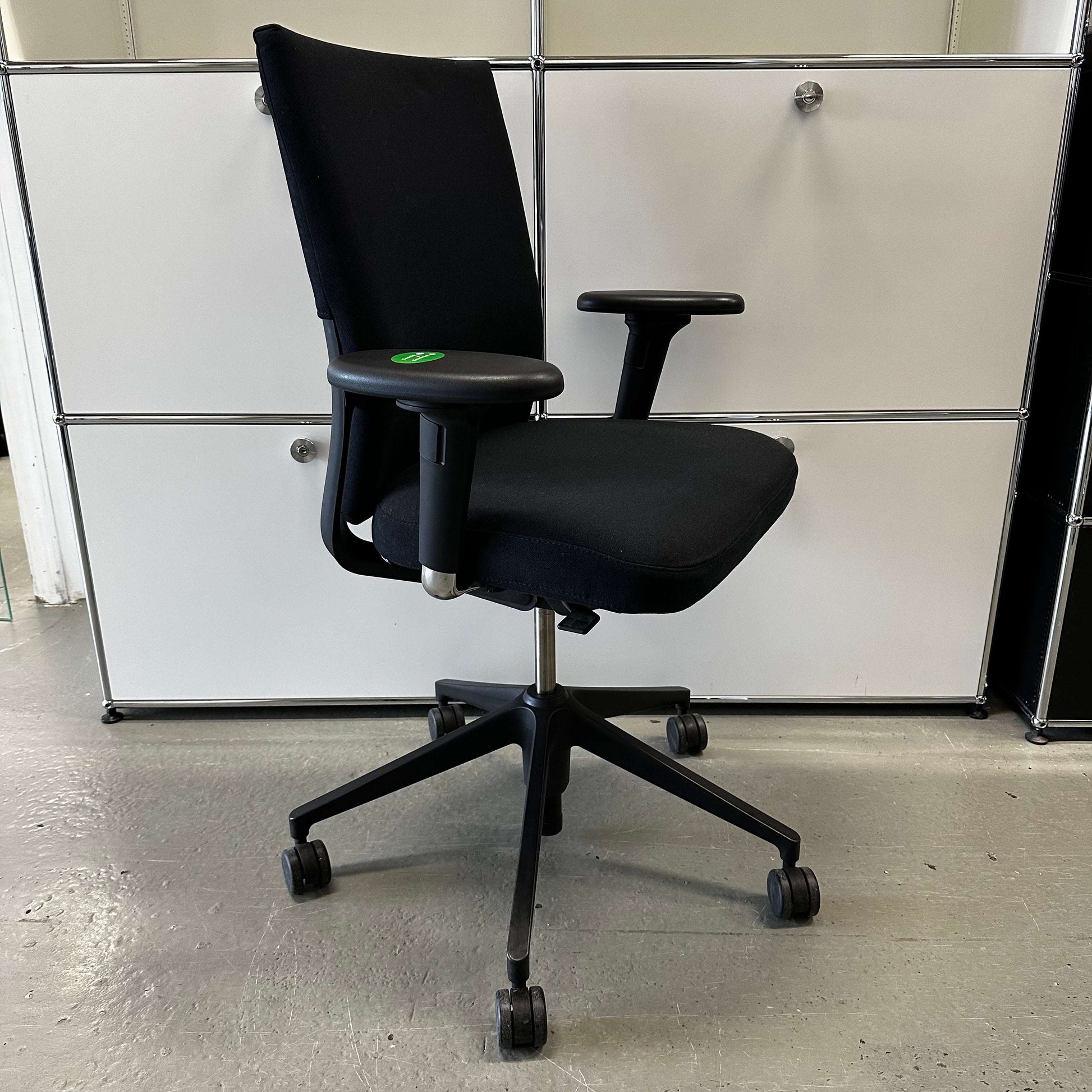 Black Vitra ID Soft ergonomic office chair with fabric upholstery and adjustable armrests on black plastic base with wheels