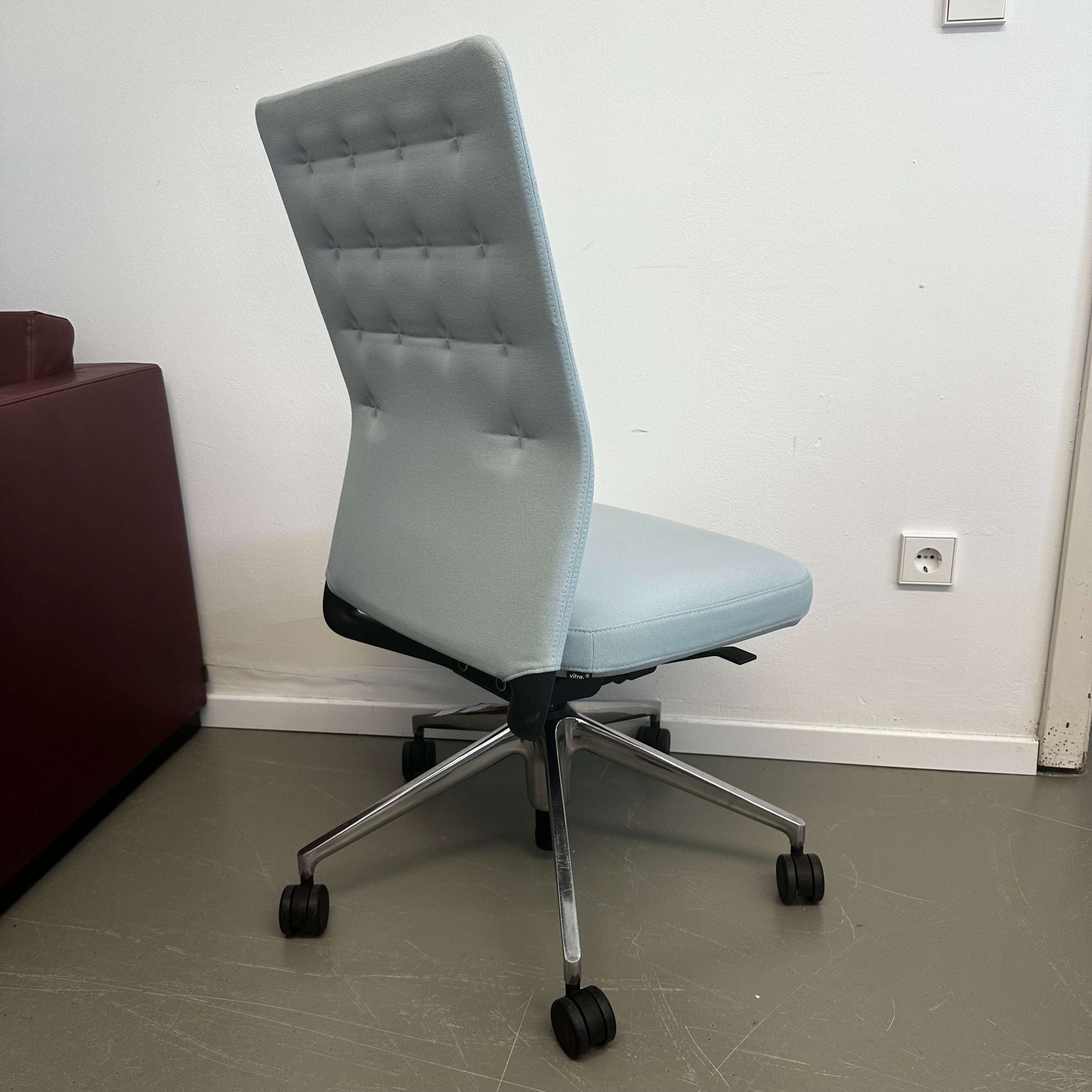 Light blue Vitra ID Trim office chair with adjustable lumbar support and casters