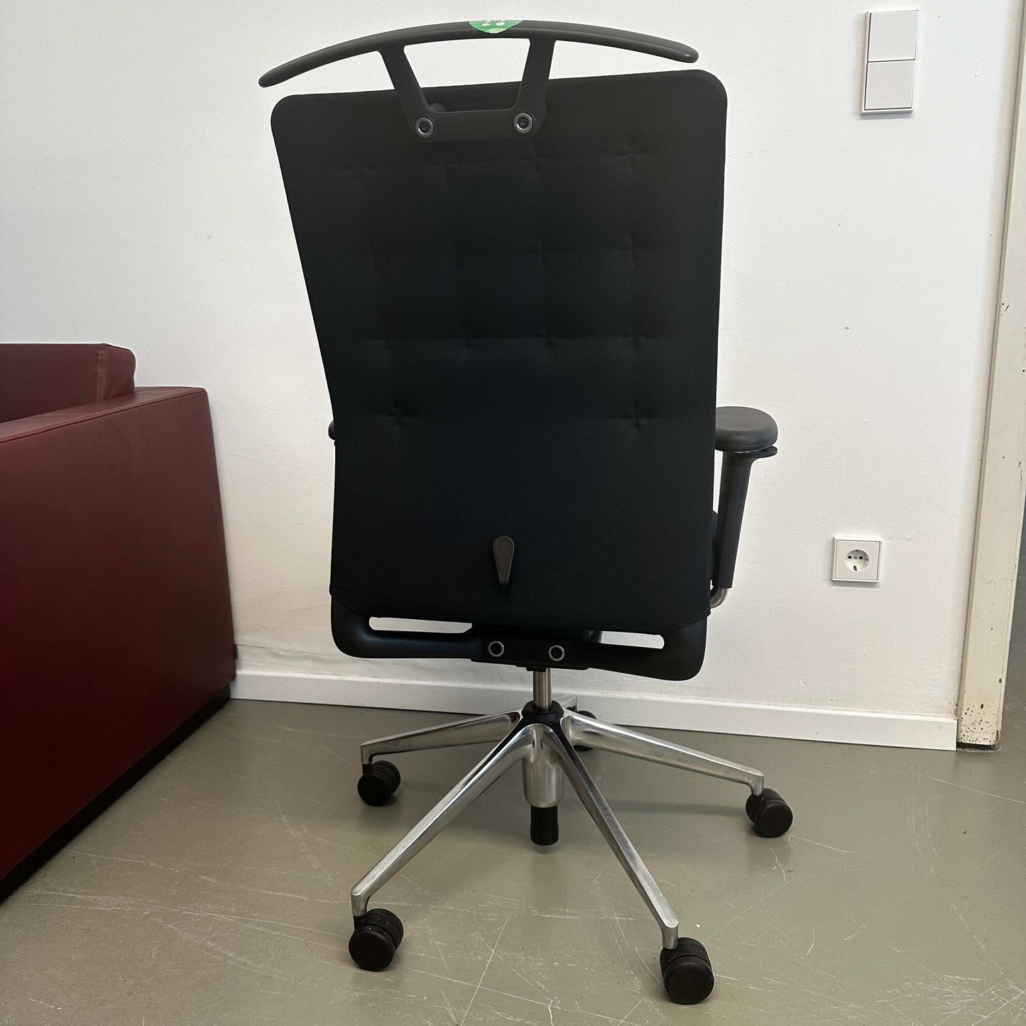 Black Vitra ID Trim ergonomic office chair with adjustable features and lumbar support viewed from the back