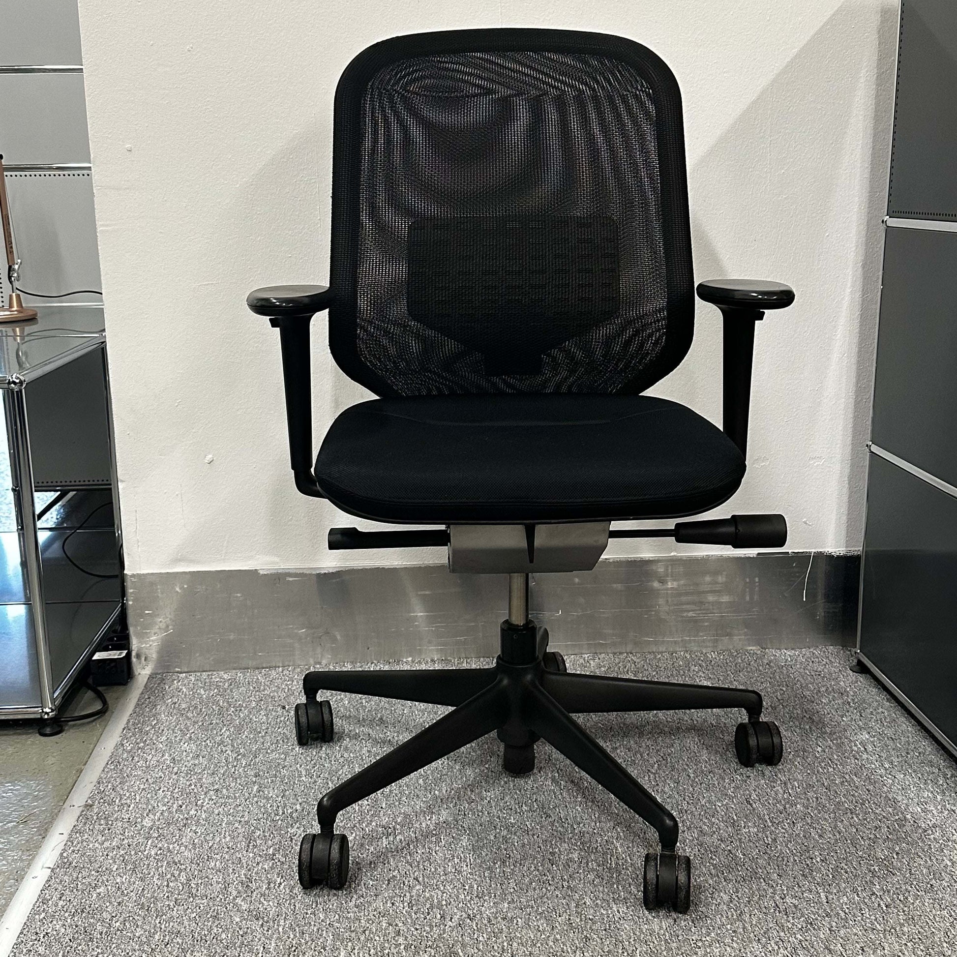 Vitra Meda Pro black office chair with adjustable height, lumbar support, and breathable mesh backrest