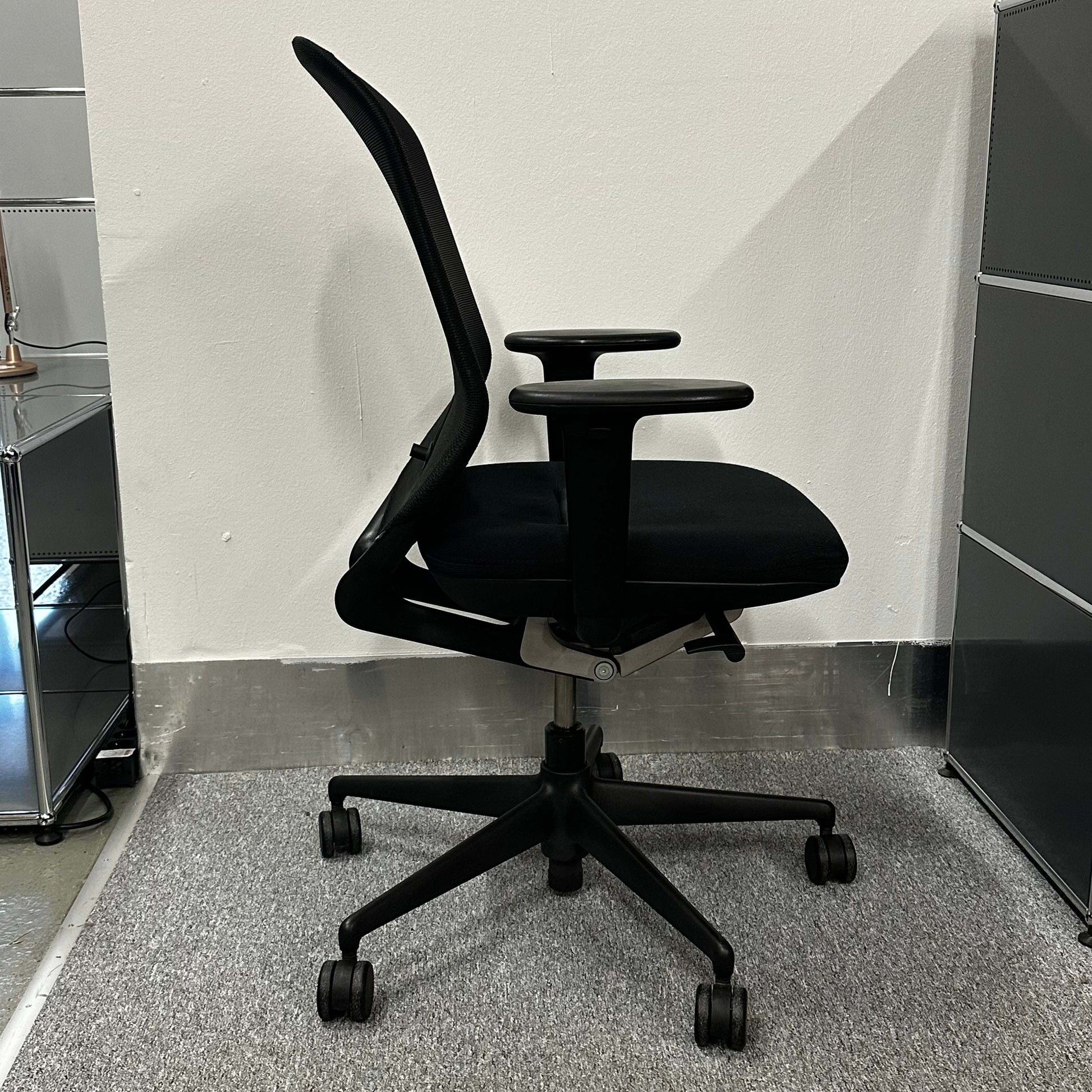 Black Vitra Meda Pro office chair with adjustable seat height, lumbar support, and breathable mesh backrest.