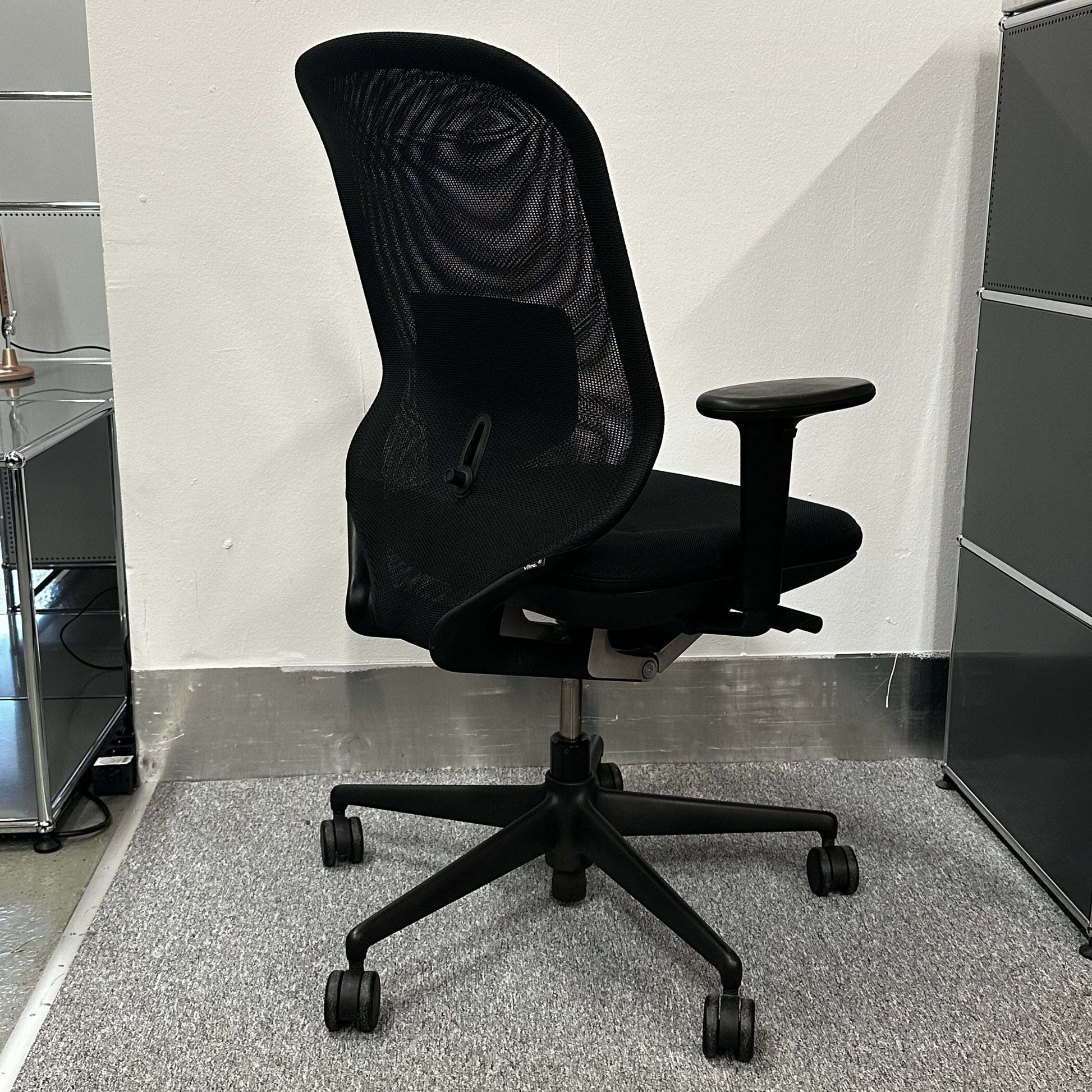 Black Vitra Meda Pro office chair with adjustable height, lumbar support, and breathable double-layer mesh backrest