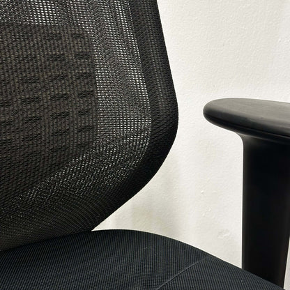 Vitra Meda Pro black office chair with adjustable seat height, lumbar support, and breathable double-layer mesh backrest