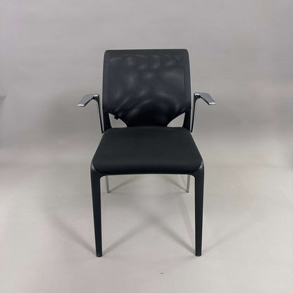 Vitra Medaslim chair with black cushioned seat, mesh backrest, and chrome armrests and frame