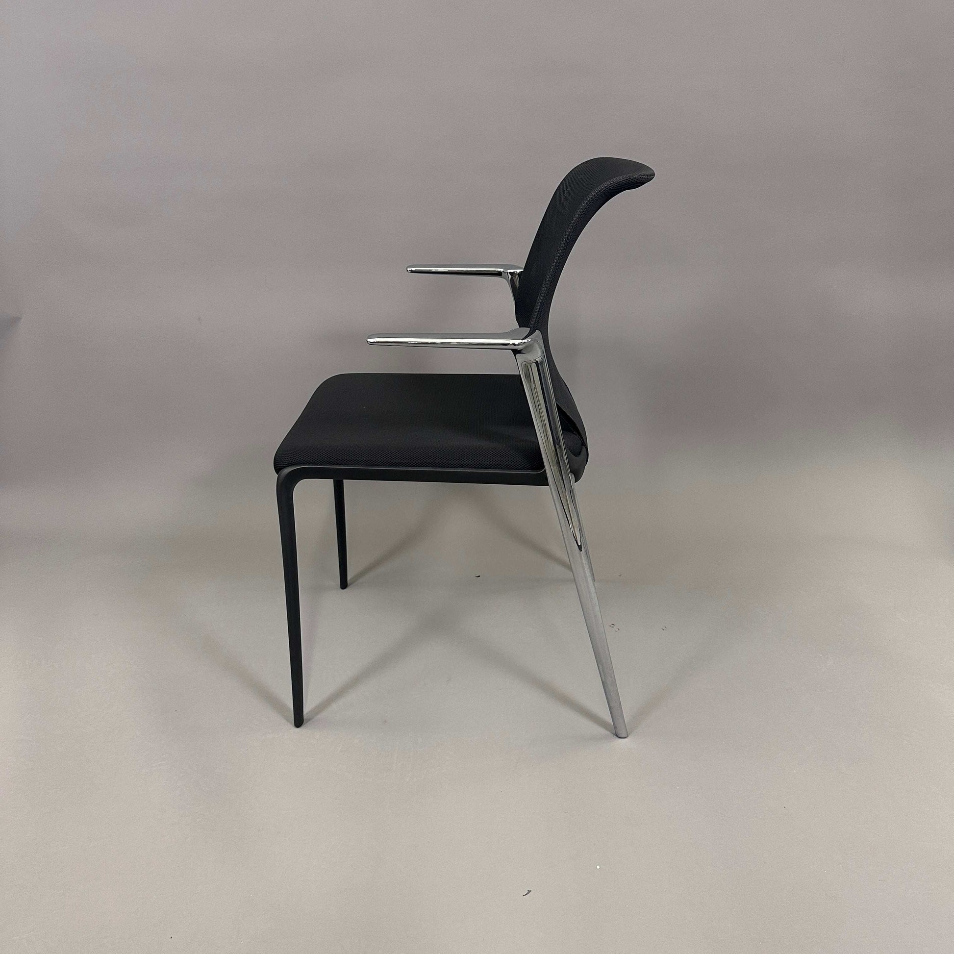 Vitra Medaslim chair with black upholstered seat, mesh backrest, chrome armrests, and chrome/plastic frame side view