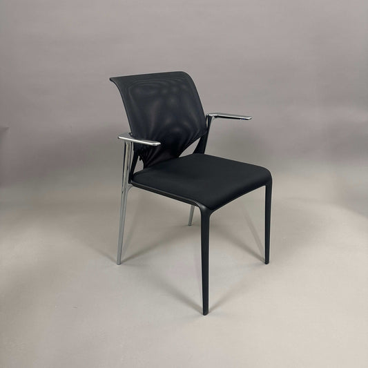 Vitra Medaslim chair with black upholstered seat, mesh backrest, and chrome armrests and frame