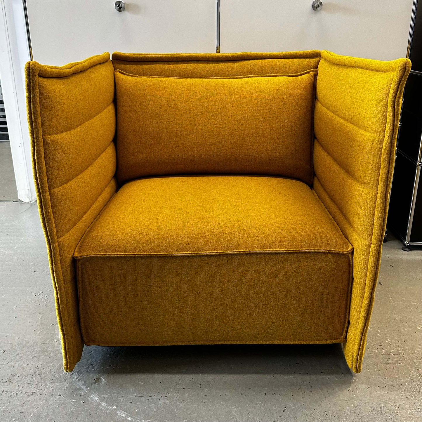 Yellow Vitra Plume Fauteuil armchair with high padded sides and backrest